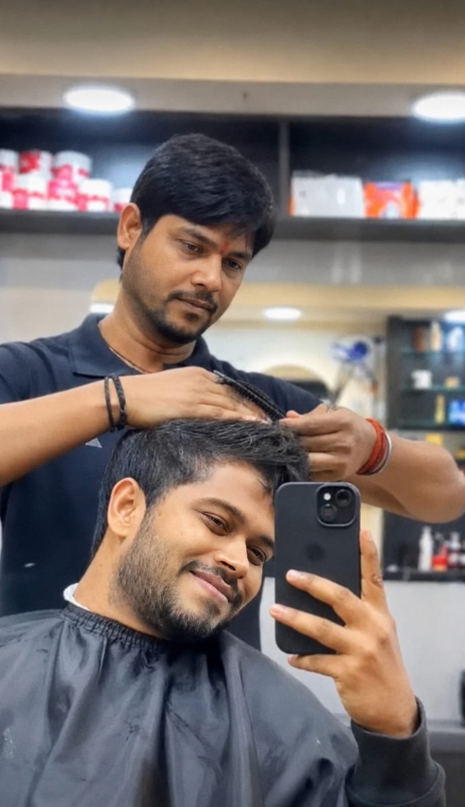 Barber styling a client's hair at STAR Men's Professional Salon